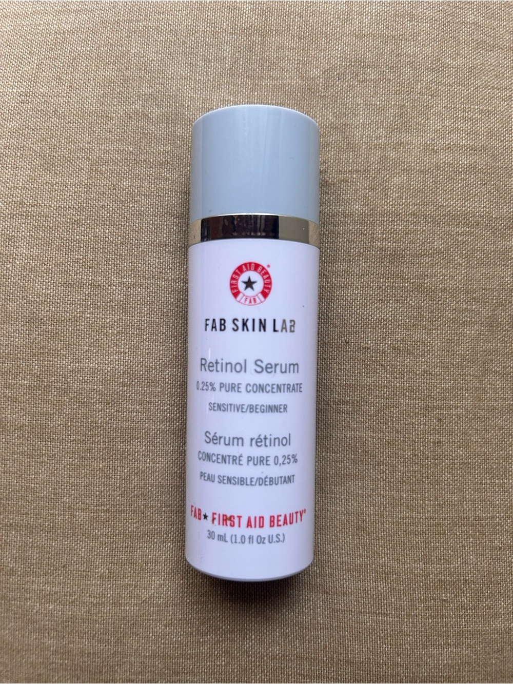First Aid Beauty Retinol Serum Bottle in White with Red Logo